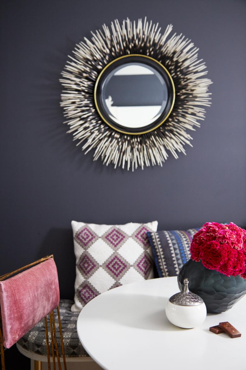 Kelley is a proponent of breaking the rules, and opted to paint her apartment a cool off-black shade. The color absolutely works as a strong backdrop for the myriad of beautiful elements that this editor and creative director has brought home. In the dining room, a beautifully textured “Porcupine Quill” Mirror from Horchow, pops against the dark black wall. The hand-painted piece has a sculptural quality, as do many of the pieces that Kelley has in her home. 
