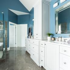 Blue Master Bathroom With White Cabinets