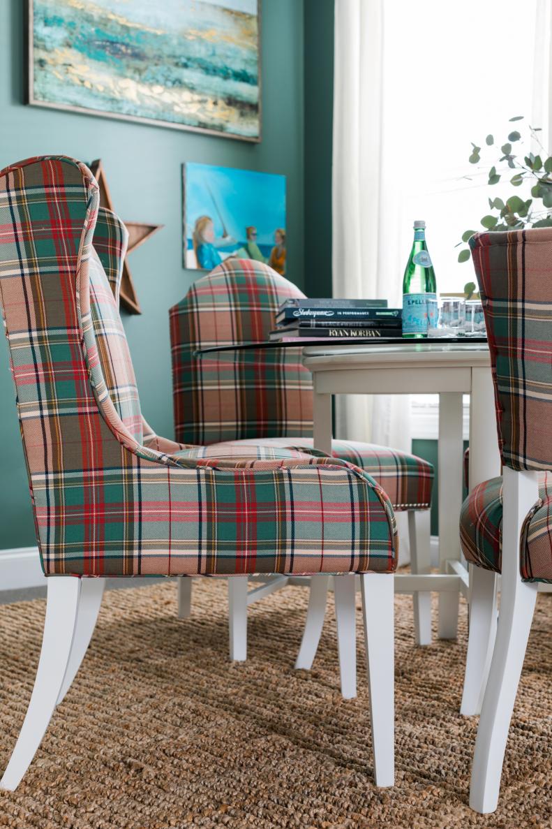 These chairs were a score at a local thrift store. Varying the styles of the chairs is a playful nod, too. A fresh coat of white paint and plaid upholstery help unify them around the table and give the space a preppy, yet modern vibe.