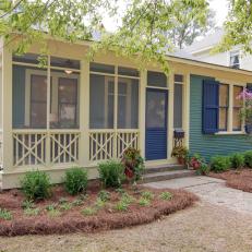 Blue Home Exterior with Updated Landscaping and Enclosed Front Porch 