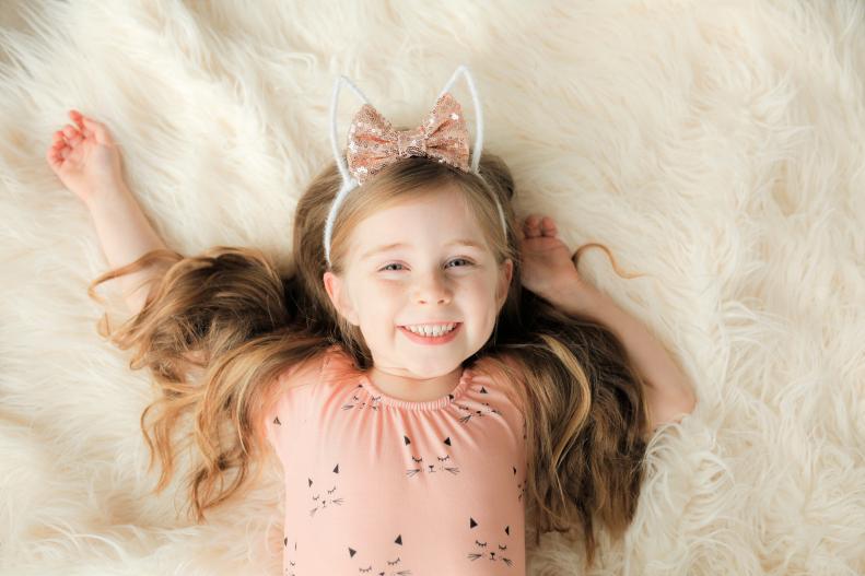 Little Girl Wearing Bunny Ears and Smiling
