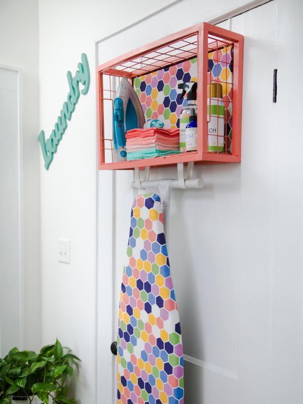 For extra organization and added style, mount a metal basket on the wall to create a shelf. Then, add a pair of straps below to store your ironing board. For an extra bit of glam, add material to the back side of the shelf that matches your ironing board.