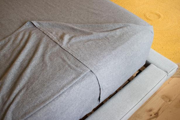 The easy way to tuck a perfectly mitered bedsheet.