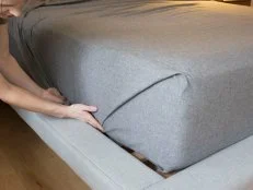 The easy way to tuck a perfectly mitered bedsheet.