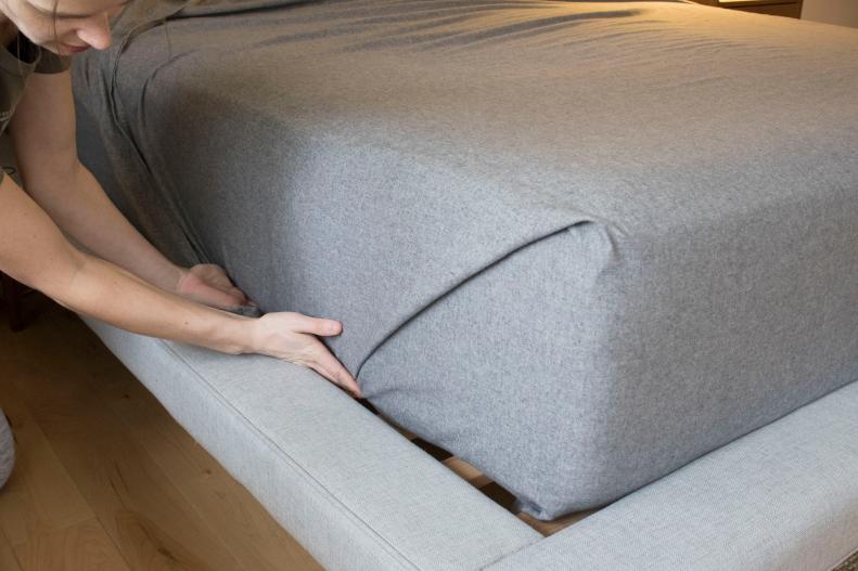 The easy way to tuck a perfectly mitered bedsheet.