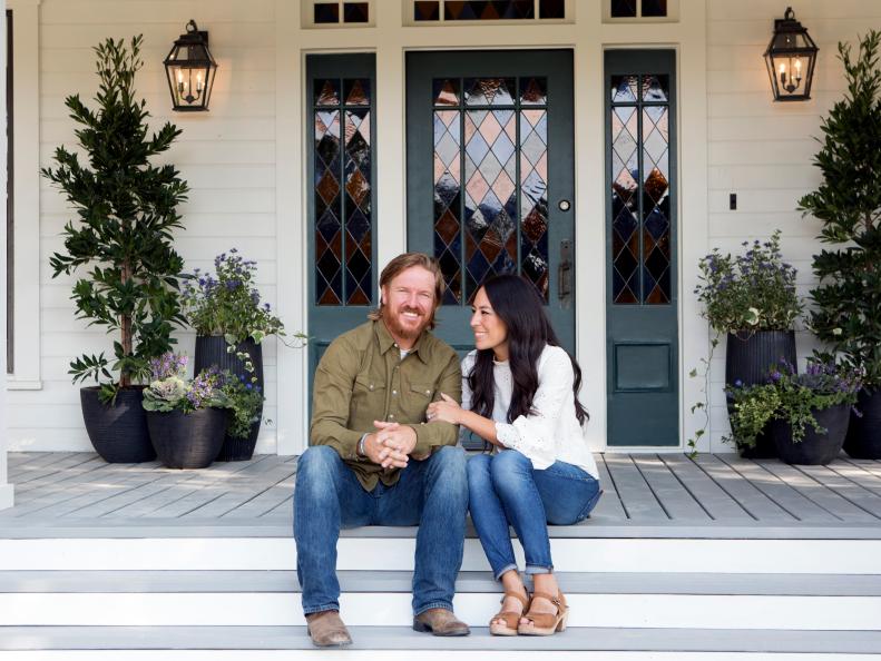 As seen on Fixer Upper, Chip and Joanna Gaines outside the Ramsey's renovated home. (Portrait)
