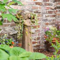 Garden Statue and Brick Wall