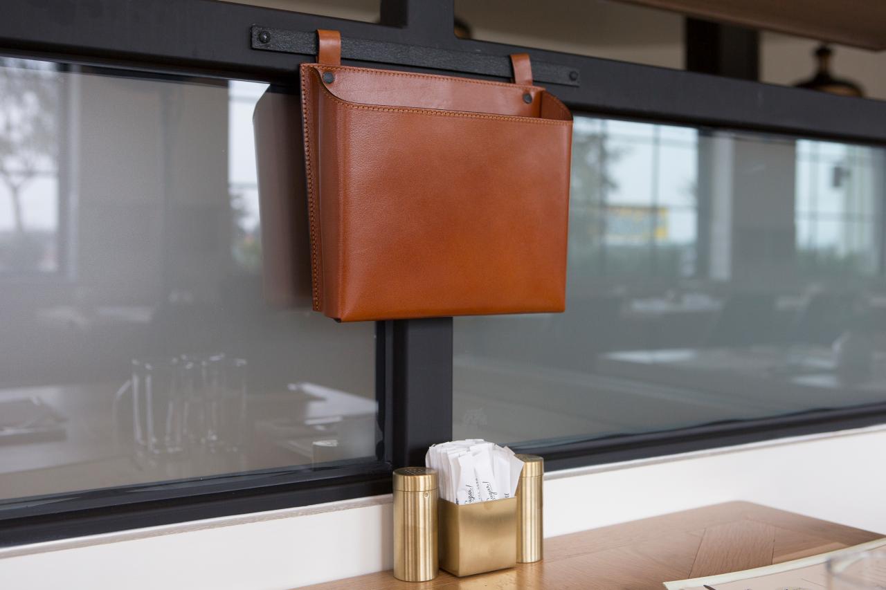 Magnolia Table restaurant - Detail of leather pouch for menu and cell phones at table. #magnoliatable