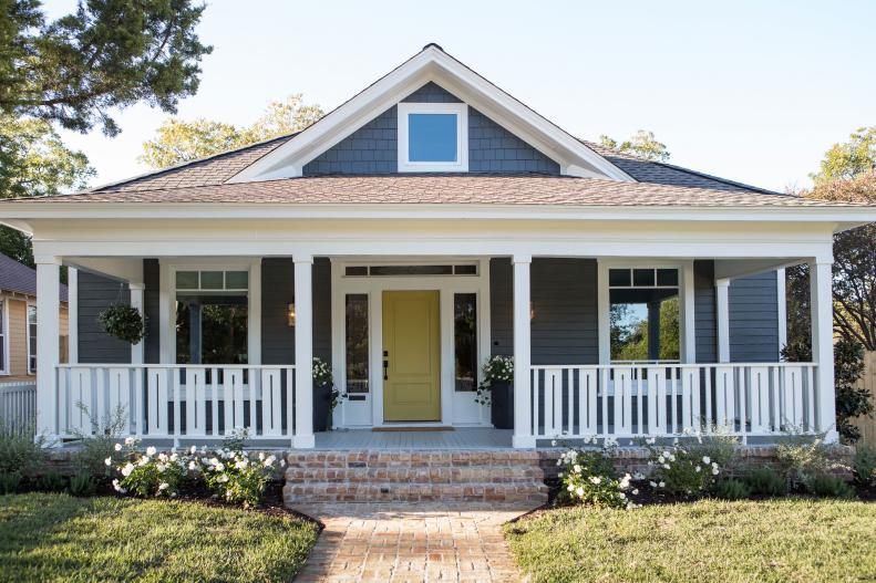 Gray Home Exterior with Yellow Front Door and White Columns/Railing 
