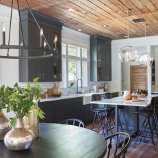 Rustic Black and White Kitchen/Dining Room with Brown Wood Ceiling 