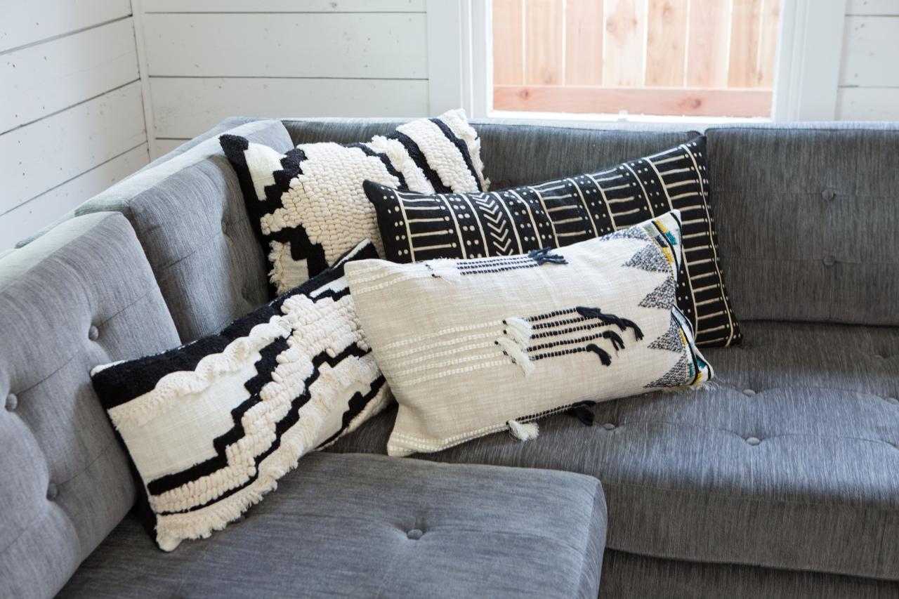 White Pillows On Gray Sofa In Black And White Rustic Living Room