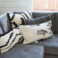 White Pillows on Gray Sofa in Black and White Rustic Living Room 