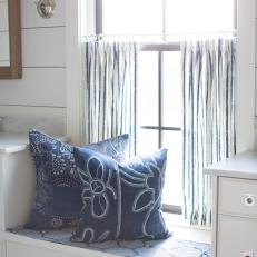 Window Seat and Blue Striped Curtains