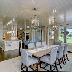 White Open Plan Kitchen and Dining Area With Water View