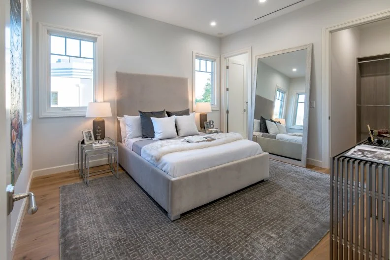 transitional guest bedroom with large mirror