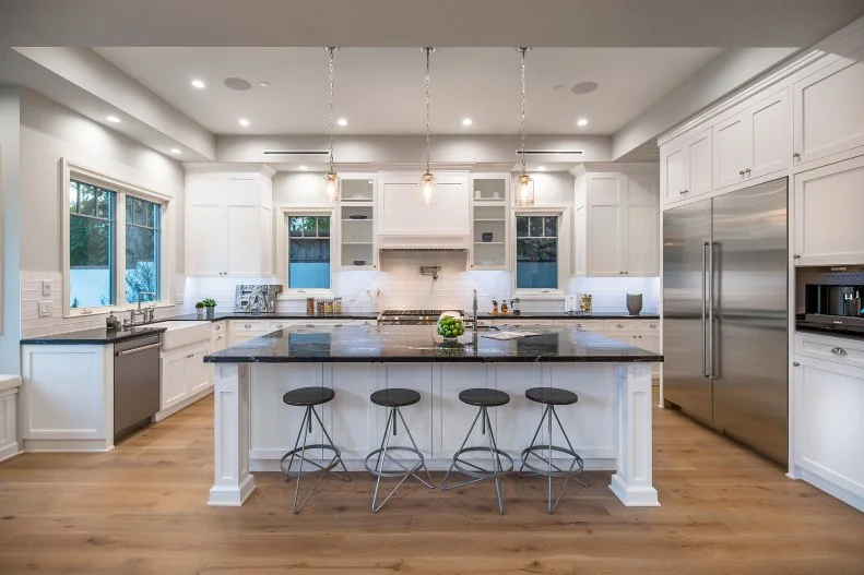 transitional kitchen island with black barstools
