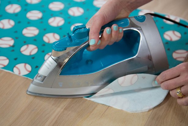 Use an iron to fuse the fabric and iron-on webbing together.
