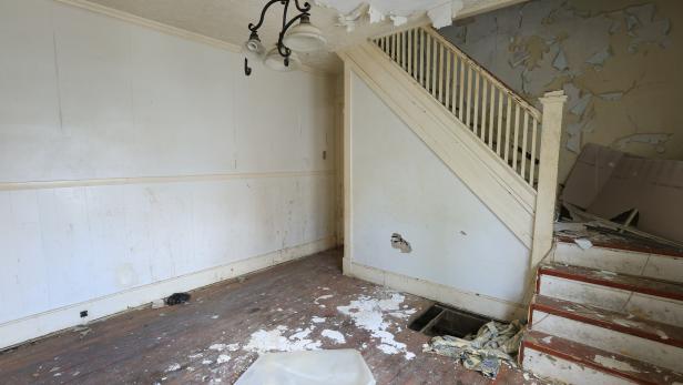 The original dinning room and staircase in the townhome that Mina and Karen are renovating as seen on Good Bones 