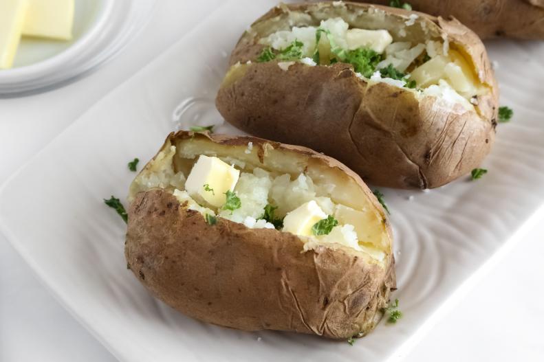 The fluffiest baked potatoes are made in an Instant Pot. Place one cup of water and four equal-sized medium potatoes on the steamer rack. After cooking for ten minutes on high or 'manual,' allow the pressure to release naturally before removing them from the pot with tongs. Garnish with your favorite potato fixings