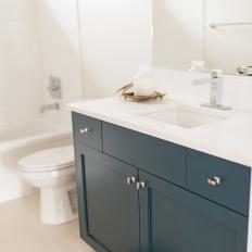 Teal Cabinets Add Fun Color to White Guest Bathroom
