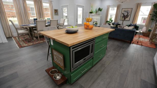 The new green kitchen island that Mina and Karen put in their modern farmhouse re-build on Sanders. The island has a custom made food shelf for Kelly and Joe's dog Booker as seen on Good Bones 