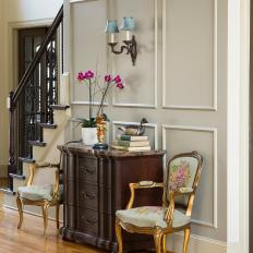 Traditional Hall Detail With Neutral Wall Color And Woodwork With Antique Side Table And Chairs