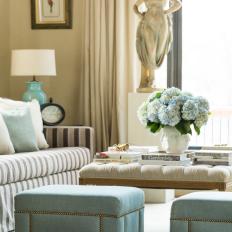 Contemporary Living Room Detail With Blue Upholstered Stools And Eclectic Art