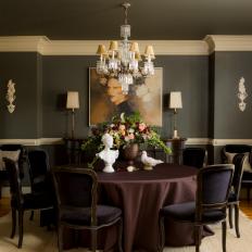 Formal Dining Room With Charcoal Wall Color Palette With White Trim And Woodwork And Crystal Chandelier