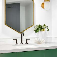 Bathroom With Hexagon-Shaped Mirror and Green Vanity