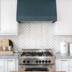 Blue-Gray Range Hood Adds Color to White Kitchen