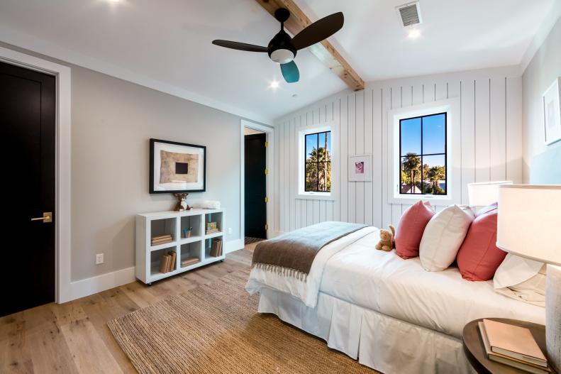 Bedroom With Shiplap Walls and Vaulted Exposed-Beam Ceiling