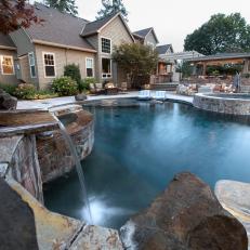Contemporary Back Yard With Pool With Stone Accents And Modern Seating Areas