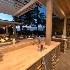 Contemporary Outdoor Kitchen And Covered Patio With Wood And Stone Details
