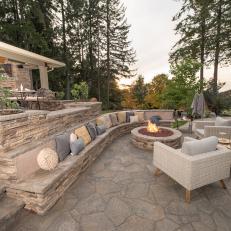 Contemporary Fire Pit With Stone Wall Seating And Arm Chairs