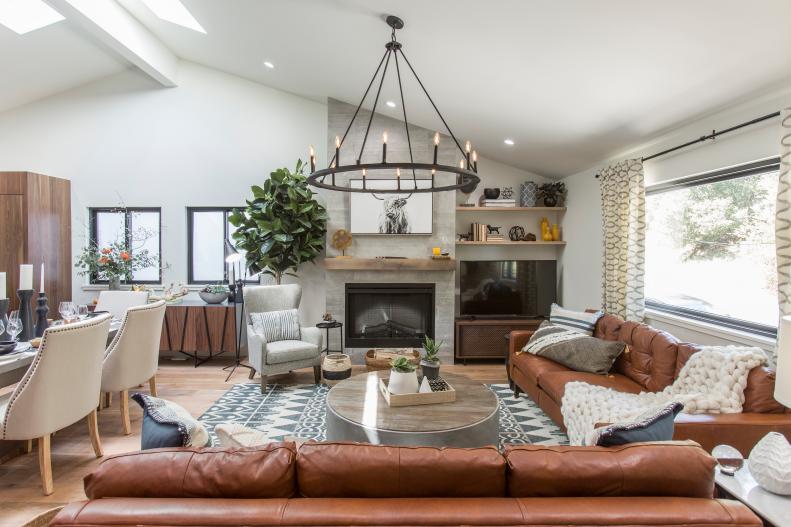 The living room of Drew Scott’s home has been completely transformed and features an open space concept leading to the dining room and kitchen, a new fireplace, and eco-skylights bringing in natural lighting, as seen on Brother vs Brother. (Before 0014).