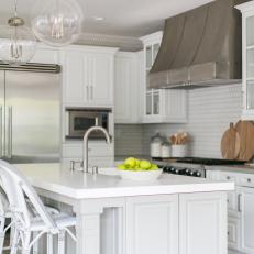 Contemporary White Kitchen With Work Island And Modern Appliances And Lighting