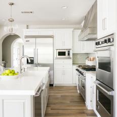 Contemporary White Kitchen With Modern Pendants And Work Island With Sink