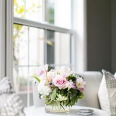 Contemporary White Living Room Side Table And Armchairs With Pastel Flower Arrangement