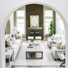 Contemporary White Living Room With Dark Wood Fireplace And Modern Coffee Table