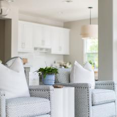 Contemporary White Living Room With Blue Upholstered Arm Chairs And White Modern Side Table