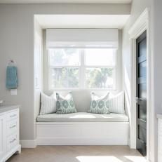 Gray and White Window Seat With Blue Pillows