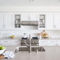 Contemporary White Kitchen With Stainless Steel Range And Vent Hood And Island Sink