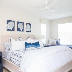 Contemporary White Bedroom With Upholstered Headboard And Blue Accents