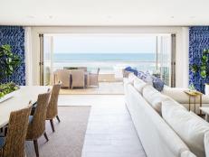 Contemporary Open Concept White And Blue Living And Dining Room With Folding Patio Doors