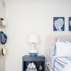 Contemporary White Bedroom With Neutral Upholstered Headboard and Blue Bedside Table