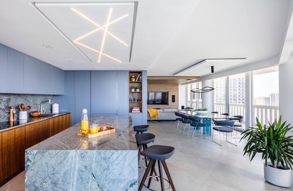 Modern Condo Open Concept Kitchen And Dining Room With Blue Cabinets and Marble Island