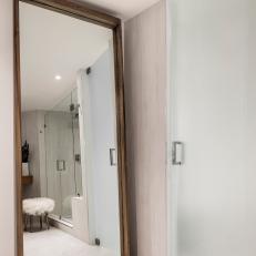 Modern Condo Bathroom With Full Length Mirror And Glass Shower Enclosure
