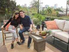 Drew Scott and fiancé Linda Phan enjoy a quiet moment on their new rooftop patio, with views of downtown of Los Angeles in the background, as seen on Property Brothers at Home: Drew’s Honeymoon House.