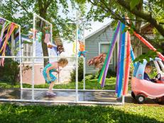 Start the summer off with a splash by building your kids their very own kiddie car wash. Complete with sprinkling water, sponges and streamers, this DIY is sure to become a summertime staple.