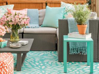 Whether you’re sprucing up your existing patio furniture with throw pillows or going all-in for a cushy sectional -you’ll want to do your homework and buy the most durable product you can afford. Look for materials that are washable, as well as water and mildew resistant. If the furniture will live in a super sunny area, shop for UV protected products so they’ll be fade resistant.  Keep in mind, polyester fabrics are inexpensive, but they don’t weather all that well, so covered use is best.  If decorating an exposed area, look for Olefin (synthetic fiber) or ideally a solution dyed acrylic like Sunbrella where the color/pattern is infused into the fibers. These fabrics are truly all-weather and easy to clean with soap and water.  
